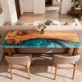 Modern hallway scene showcasing an olive wood console table with emerald pearlescent epoxy inlay and dramatic swirling grain.