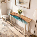 Entryway styling vignette with an olive wood green pearl epoxy console table, round mirror, and minimalist decor accents.