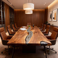 Black walnut river epoxy conference table set for a client meeting in a warm wood-paneled office.