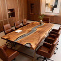 Black walnut epoxy resin conference table in a modern executive boardroom with leather swivel chairs.