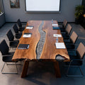 Team meeting setup with a black walnut epoxy resin conference table in a minimalist executive office.