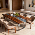 Modern living room scene showcasing a black walnut river epoxy table with silver-gray resin inlay and rich natural wood grain.