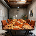 Home dining room interior with an olive wood epoxy dining table, artistic amber resin pattern, and upholstered dining chairs.