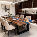 Black walnut epoxy resin dining table in a modern dining room, featuring an ocean-blue river epoxy with floating wood inlays and glossy finish.
