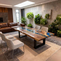 Luxury open-concept living area with a black walnut ocean-blue epoxy table, highlighting dramatic grain contrast and resin depth.