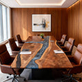 Executive meeting room scene with a black walnut river epoxy conference table, smoky silver resin channel, and ergonomic office chairs.