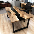 Executive office scene showcasing a black walnut epoxy resin desk with black resin river design and polished surface reflections.