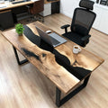 Modern corporate workspace featuring a black walnut black river epoxy desk, clean lines, and professional desk setup.
