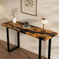 Contemporary foyer interior showcasing an olive wood black epoxy console table, rich swirling wood figure and polished surface reflections.