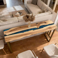 Walnut epoxy resin table featuring a royal blue resin river inlay with glossy finish and rich natural wood grain.