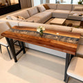 Modern dining room scene showcasing a walnut silver-gray epoxy river table with marbled depth and polished surface reflections.