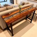 Contemporary living room setting with a walnut epoxy resin table, smoky silver resin channel, and clean minimalist decor.