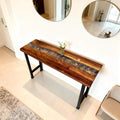 Open-concept home interior showcasing a walnut silver river epoxy table with high-gloss finish and statement tabletop character.