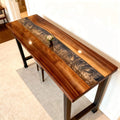 Modern home office scene with a walnut epoxy resin desk, silver-gray resin river inlay, and organized workstation setup.
