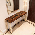 Contemporary living room setting with a black walnut epoxy resin table, sleek black resin channel, and minimalist decor.